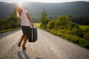 lady-carrying-heavy-suitcase-iStock_000007318113XSmall